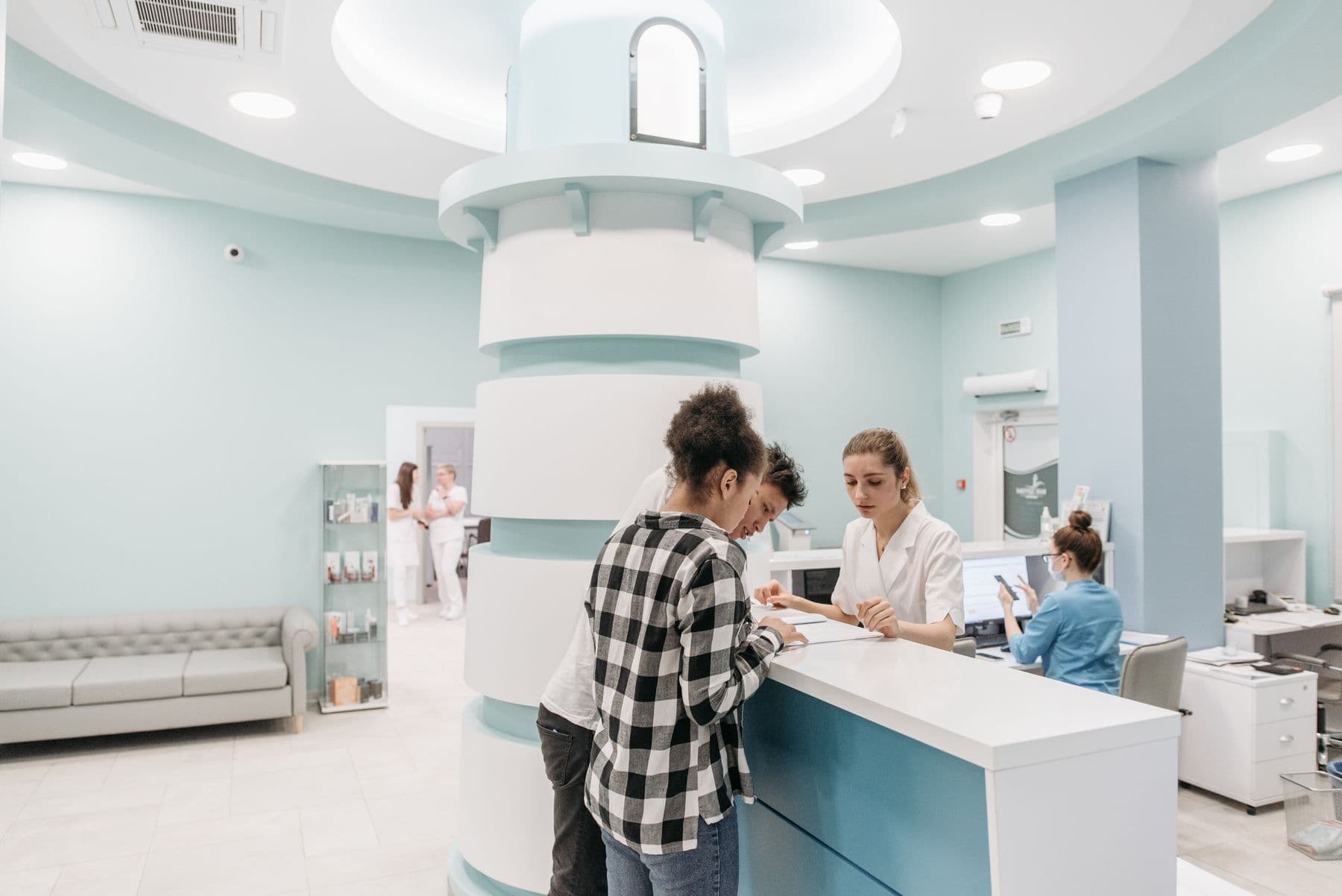 Patients and staff at the reception desk of an eye clinic